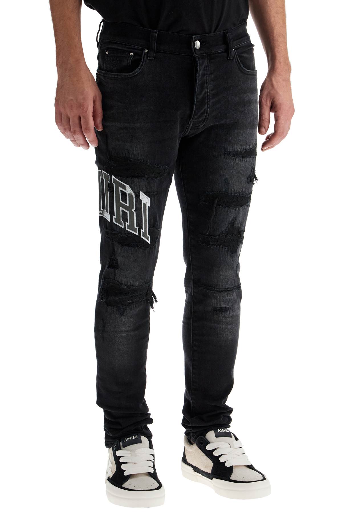 Amiri skinny jeans with varsity logo image 1